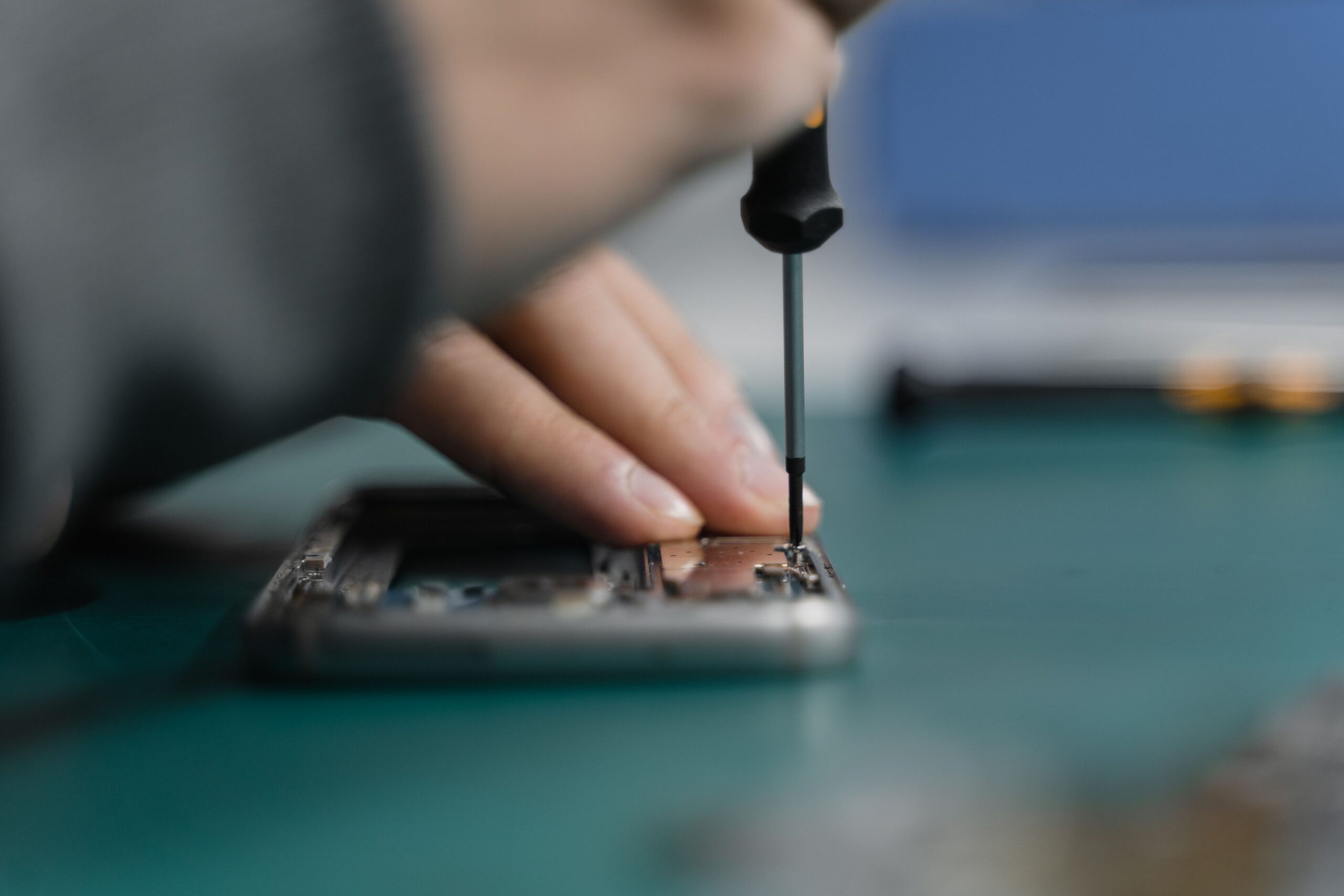 Technician repairing a smartphone